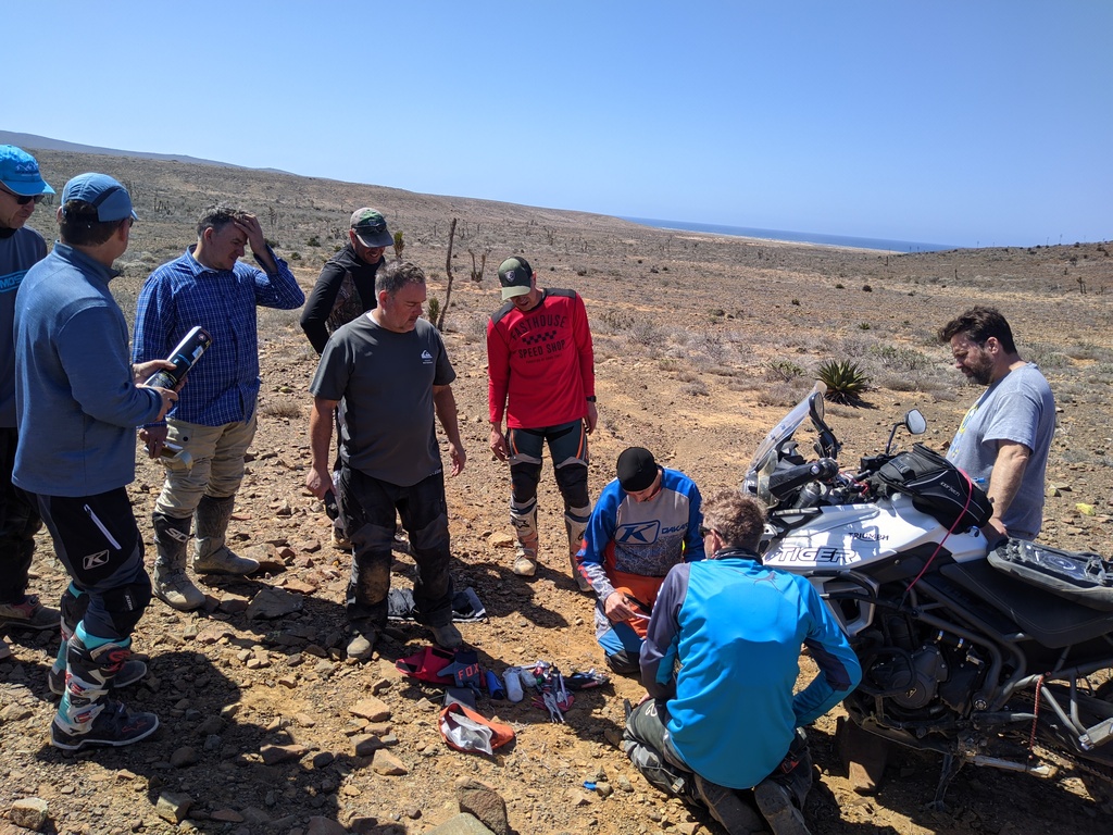 how many moto riders does it take to fix a flat tire? of course they didn’t bring the wrench to take the wheel off…