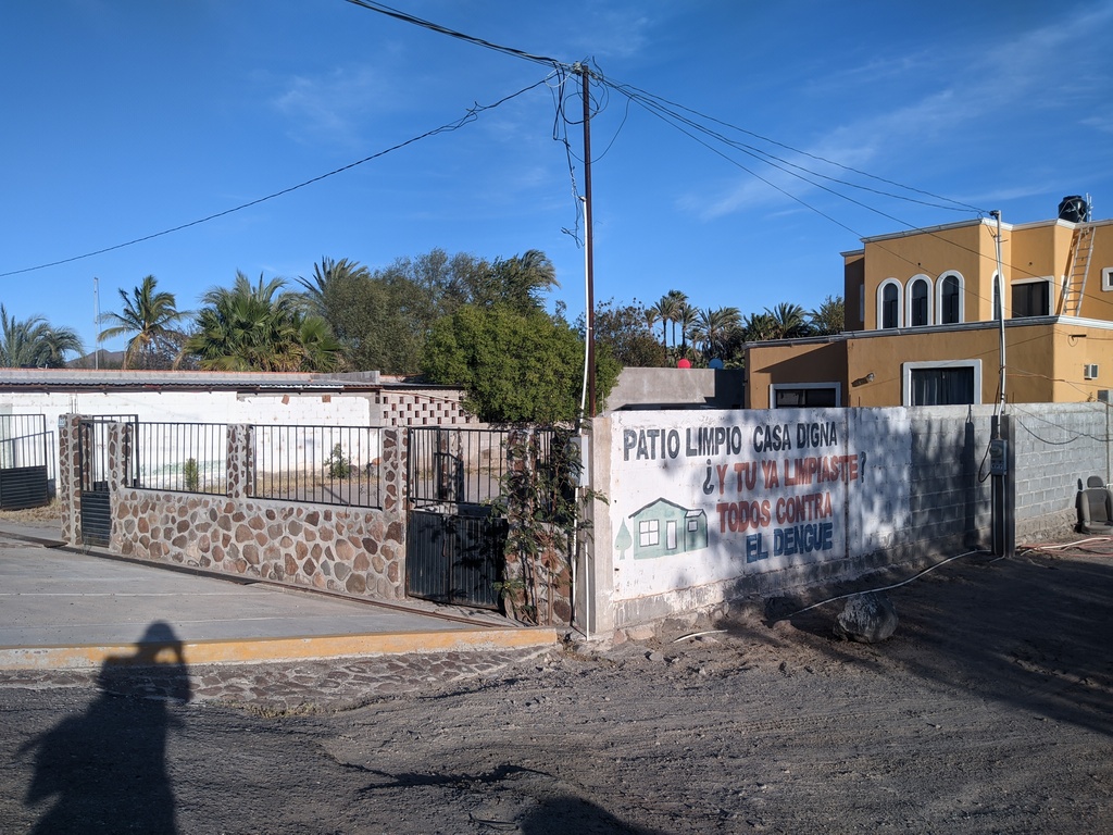 this sign says Clean Patio, Dignified House. Have you cleaned yet? everyone together against the dengue